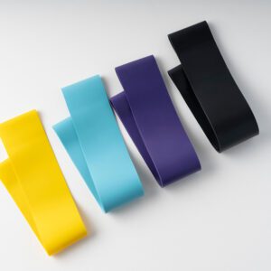 A group of four different colored bands sitting on top of a table.